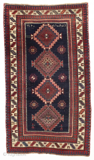 antique kazak or gendge rug with interesting inscriptions. Good thick medium length pile. All natural colors. "As found", very very dirty and with old moth nibbles (dinners) in the deep blue ground.  ...