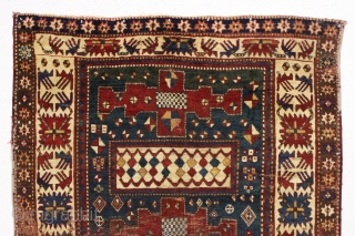 Early large kazak rug. Unusual and archaic kazak with karachopf family resemblance but on it's own branch of the family tree. I am transfixed by the mysterious ivory boxes filled with carnival  ...