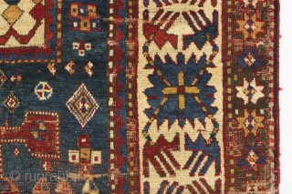 Early large kazak rug. Unusual and archaic kazak with karachopf family resemblance but on it's own branch of the family tree. I am transfixed by the mysterious ivory boxes filled with carnival  ...