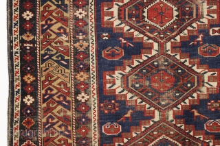 antique caucasian shirvan rug in fair condition for an older example. A karagashli variant with all natural colors featuring a pretty gold colored main border. Even low cut pile with scattered wear  ...