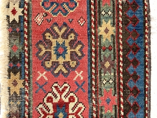 Antique little fragment of an older caucasian rug with beautiful old colors. Delicate drawing and deep brown oxidation. Lovely old purples, greens and yellows. Mid 19th c. 13” x 33”   