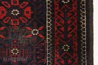 Old baluch rug with mina khani design field and an interesting border. Unusually small size for the type. All good colors featuring a strong ember red. Overall fair condition with mostly good  ...