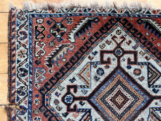 Antique little northwest Persian bagface or mat (likely). Attractive ivory medallion surrounded by scattered herati elements. Some edge unraveling and a small gouge. Good natural colors. Even low pile. Depressed weave. Could  ...