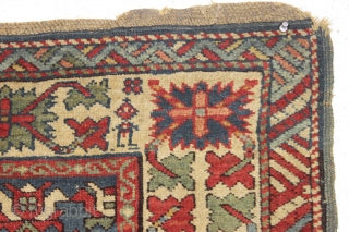 Old caucasian rug, possibly kazak, with unusually good colors but in distressed condition. The large range of natural colors contains lovely greens and blues and a very fine old apricot orange. Very  ...