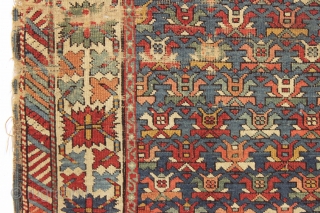 Old caucasian rug, possibly kazak, with unusually good colors but in distressed condition. The large range of natural colors contains lovely greens and blues and a very fine old apricot orange. Very  ...