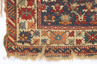 Old caucasian rug, possibly kazak, with unusually good colors but in distressed condition. The large range of natural colors contains lovely greens and blues and a very fine old apricot orange. Very  ...