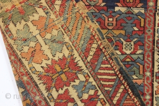 Old caucasian rug, possibly kazak, with unusually good colors but in distressed condition. The large range of natural colors contains lovely greens and blues and a very fine old apricot orange. Very  ...