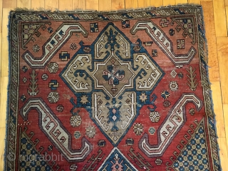 Old large Caucasian rug. Interesting design reminiscent of early karrabaugh pieces. New England rug, as found, dirty, worn and rough as shown. I see one sewn up crease. Selvages all trimmed and  ...