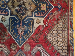 Old large Caucasian rug. Interesting design reminiscent of early karrabaugh pieces. New England rug, as found, dirty, worn and rough as shown. I see one sewn up crease. Selvages all trimmed and  ...