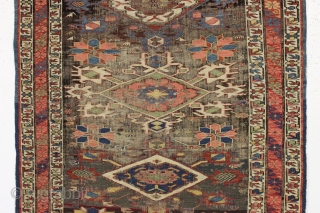 Antique caucasian kuba soumak long rug. Great yellows and greens. Original sides and end finish. The heavily oxidized brown ground has areas poorly filled in and should be restored. The design elements  ...