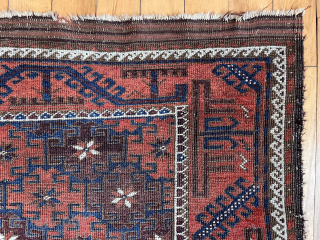 Antique Baluch rug in decent condition for the age. Some low pile and brown oxidation. Uncommon field design of diagonal bands of large latch hooked devises with star centers. Original goat hair  ...