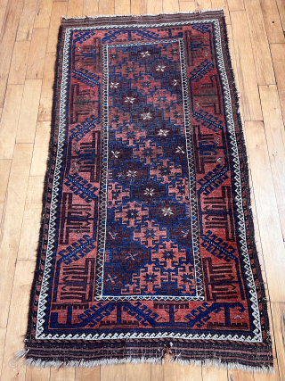 Antique Baluch rug in decent condition for the age. Some low pile and brown oxidation. Uncommon field design of diagonal bands of large latch hooked devises with star centers. Original goat hair  ...