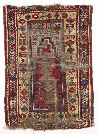 Early Turkish or perhaps Kurdish prayer rug. Interestingand unusual older example in very rough condition. Beautiful natural colors. Fleecy wool. Bits of old crude repair. Could be restored. Good age, ca. 1850.  ...