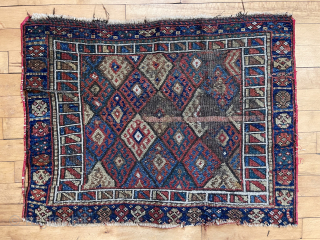 Old Kurdish diamond bagface with attractive “signal flag” border. Overall rough with heavy wear and edge unraveling. All good natural colors but very dirty. Large size. 32” x 41”. 19th c. Study  ...