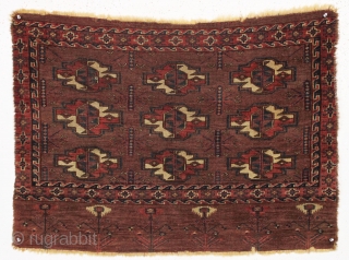 antique yomud chuval. Older example with eye catching elem panel. Good allover  pile. All natural colors. Slight edge damage as shown. 3rd qtr. 19th c. 29" x 40"    