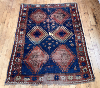 Early large Kazak rug in rough condition. Bold design with all natural colors. Lovely greens. Creases, heavy wear, well placed hole. Badly abused but still brings a smile. Priced accordingly. Mid 19th  ...