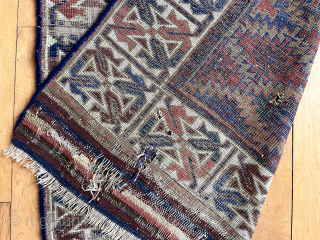 Antique Turkish knotted Baluch rug with an eye catching wide ivory border. Overall rough with low pile with heavy wear and substantial brown oxidation. Can’t quite put my finger on why but  ...