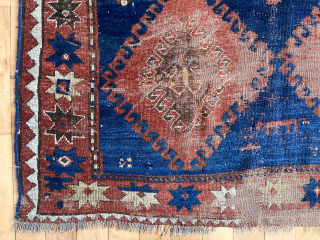Early large Kazak rug in rough condition. Bold design with all natural colors. Lovely greens. Creases, heavy wear, well placed hole. Badly abused but still brings a smile. Priced accordingly. Mid 19th  ...