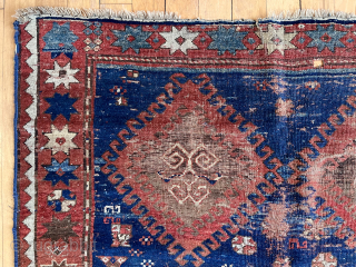 Early large Kazak rug in rough condition. Bold design with all natural colors. Lovely greens. Creases, heavy wear, well placed hole. Badly abused but still brings a smile. Priced accordingly. Mid 19th  ...