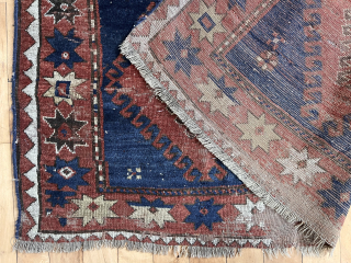 Early large Kazak rug in rough condition. Bold design with all natural colors. Lovely greens. Creases, heavy wear, well placed hole. Badly abused but still brings a smile. Priced accordingly. Mid 19th  ...