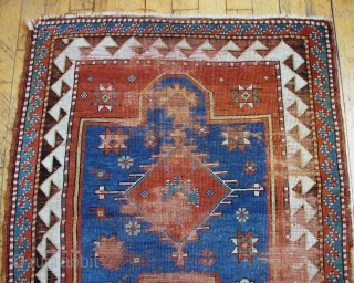 Antique very small Kazak prayer rug. Nice old piece in need of restoration. All good natural colors. Fresh and dirty. 19th c. 3' 3" x 3' 11"      