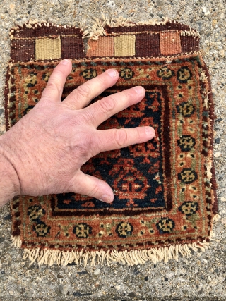 Antique tiny bagface. As found, in need of a good wash. Mostly good pile, some wear as shown. Original closure tabs. Edges rough. Single wefted, cotton warped, probably northwest Persian. Good natural  ...