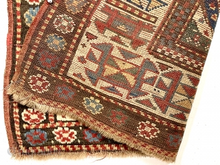 Antique Caucasian Kazak rug with interesting design features and a very unusual narrow size. The weaver altered an otherwise typical diagonal striped field with width and design changes. The extra wide ivory  ...