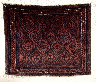 Early large Baluch bagface with rich color and beautiful soft lustrous wool. Complex diamond lattice field with a delicate meander border. Overall good pile. Original selvages. Wonderful cloth like handle. All natural  ...