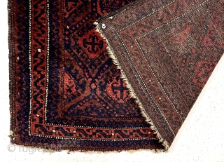 Early large Baluch bagface with rich color and beautiful soft lustrous wool. Complex diamond lattice field with a delicate meander border. Overall good pile. Original selvages. Wonderful cloth like handle. All natural  ...