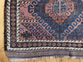 Antique small Baluch rug with some unusual features. A mini runner, rather narrow for its length. In the “mushwani” design family with its latch hooked field. An unusual border  that I  ...