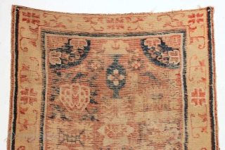 Early Kansu rug. Old piece. Old design. Old colors. Simply old. Transcendental border.  It's a marvel something this age would be without holes or repair. Indescribably low pile. Could use a  ...