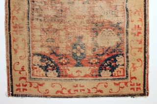 Early Kansu rug. Old piece. Old design. Old colors. Simply old. Transcendental border.  It's a marvel something this age would be without holes or repair. Indescribably low pile. Could use a  ...