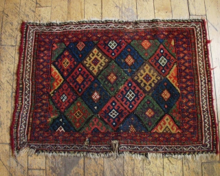 Antique Kurdish bagface. Excellent natural colors including a fine purple and a very good yellow. Rough condition. ca. 1880   2"1" x  3'        