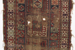 early ghost of a kazak rug. Splash of karrabaugh with a hint of karachopf. Indescribable condition. Priced accordingly. All good natural colors and reasonably clean. 3'6" x 8'3"     