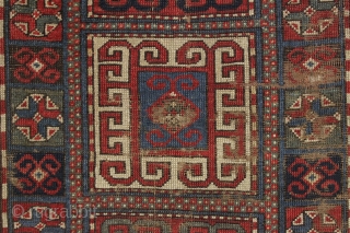 early ghost of a kazak rug. Splash of karrabaugh with a hint of karachopf. Indescribable condition. Priced accordingly. All good natural colors and reasonably clean. 3'6" x 8'3"     