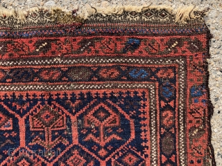 Antique little Baluch bagface with classic lattice and inset flowering plants. Better than average drawing and natural colors for this well known type. Excellent light blues and attractive reds. Unfortunately in somewhat  ...