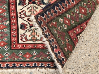Antique ivory ground northwest Persian bagface with an unusual field design. Photos taken as woven, probably upside down. The little checked floral motifs are quite eye catching. Pretty green border. Overall even  ...