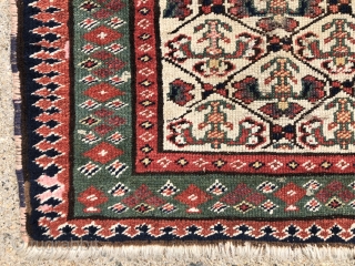 Antique ivory ground northwest Persian bagface with an unusual field design. Photos taken as woven, probably upside down. The little checked floral motifs are quite eye catching. Pretty green border. Overall even  ...