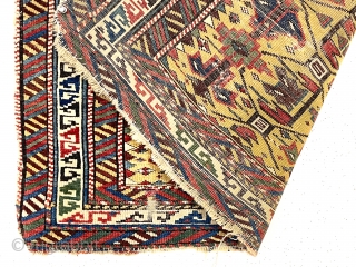 Antique little yellow ground Caucasian kuba rug with an archaic overall lattice design. Pile varies from decent low to very low in spots with some foundation showing. Minor edge loss all around.  ...