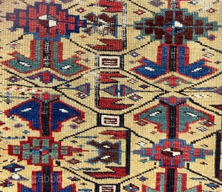 Antique little yellow ground Caucasian kuba rug with an archaic overall lattice design. Pile varies from decent low to very low in spots with some foundation showing. Minor edge loss all around.  ...