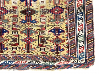 Antique little yellow ground Caucasian kuba rug with an archaic overall lattice design. Pile varies from decent low to very low in spots with some foundation showing. Minor edge loss all around.  ...