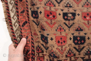 Antique small Baluch rug. Soft, supple and sophistacated. Older piece with very delicate drawing. All natural colors including a beautiful soft purple. Camel wool ground. Fair condition for the age with some  ...