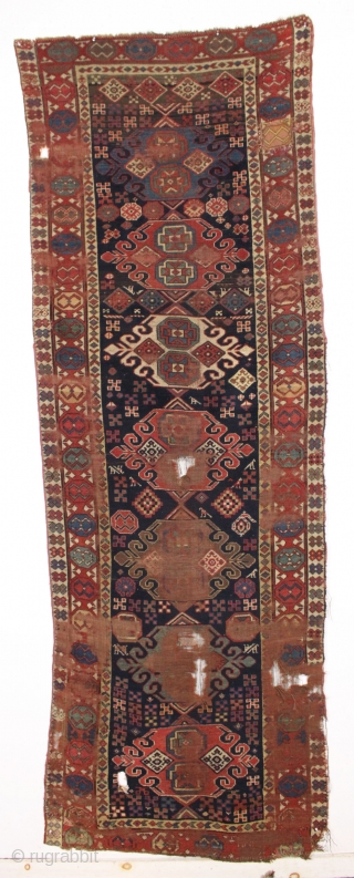 antique caucasian long rug in as found condition. An early example with unusual and elegant medallions. Beautiful border. All good natural colors. Soft and supple like cloth. A hard life with scattered  ...