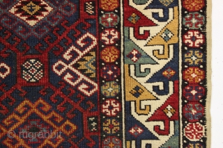 Antique very colorful little caucasian rug in good condition. Eye catching "dragons tooth" border. All good saturated natural colors featuring beautiful greens, multiple blues and nice old yellows and golds. Original selvages.  ...