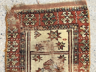 Antique fragment of an early yastik or small rug, likely Anatolian. Interesting overall soft palette with what I a very light yellow ground and a pretty apricot main border. Substantial wear and  ...