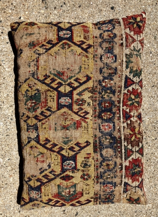 Pair of early sounak rug fragments made into pillows. Uncommon design of tulip palmettes on a soft yellow ground. Scattered wear as shown. Sewn all around and stuffed lightly. Not opened. Reasonably  ...