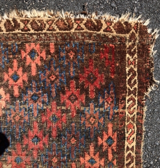 Antique Turkish knotted Baluch rug with an interesting and uncommon design. As found, in rough condition with heavy brown oxidation, wear, edge unraveling, loss. All natural colors. Nice floppy handle. Very dirty.  ...