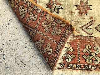 Antique fragment of an early yastik or small rug, likely Anatolian. Interesting overall soft palette with what I a very light yellow ground and a pretty apricot main border. Substantial wear and  ...