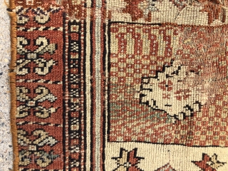 Antique fragment of an early yastik or small rug, likely Anatolian. Interesting overall soft palette with what I a very light yellow ground and a pretty apricot main border. Substantial wear and  ...