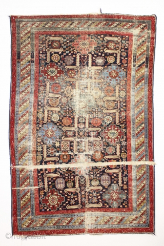 Strange remnant of an old shirvan rug with large areas of light blue cotton pile including most of the minor borders. Never seen anything quite like it before. Bad person cut rug.  ...